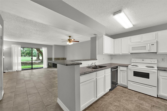 kitchen featuring light tile patterned flooring, white appliances, ceiling fan, kitchen peninsula, and white cabinets