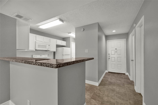 kitchen featuring decorative backsplash, white cabinets, light tile patterned floors, kitchen peninsula, and white appliances