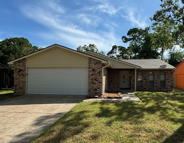 ranch-style house featuring a front yard and a garage