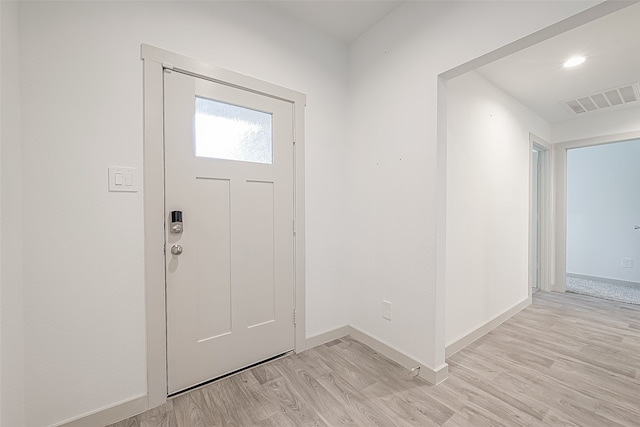 foyer entrance with light hardwood / wood-style floors