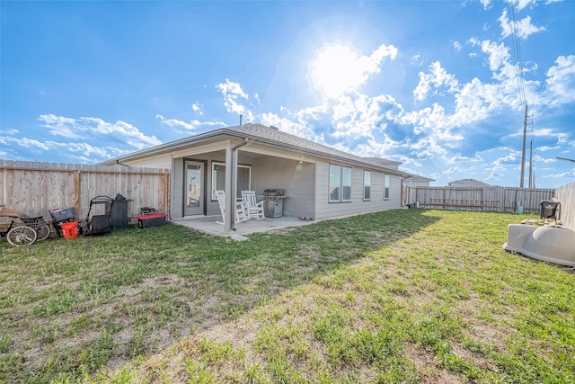 back of house with a lawn and a patio area