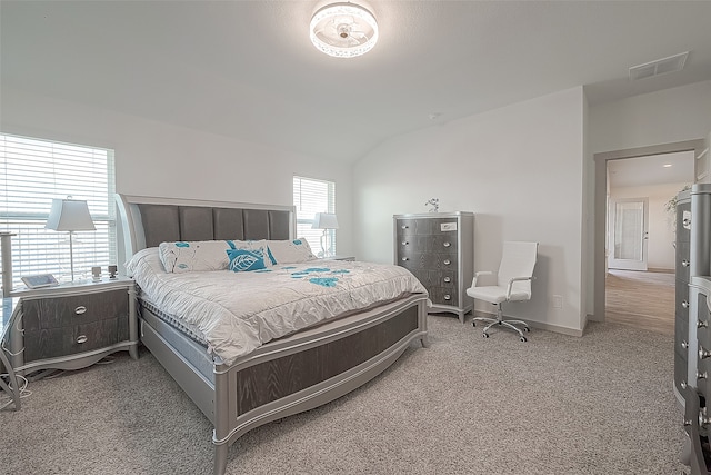 carpeted bedroom with vaulted ceiling