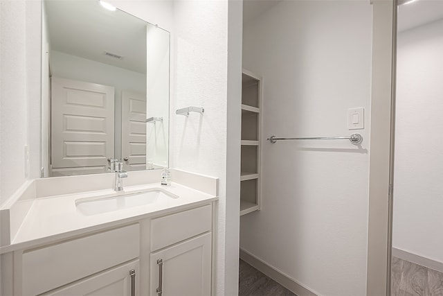 bathroom featuring hardwood / wood-style floors and vanity