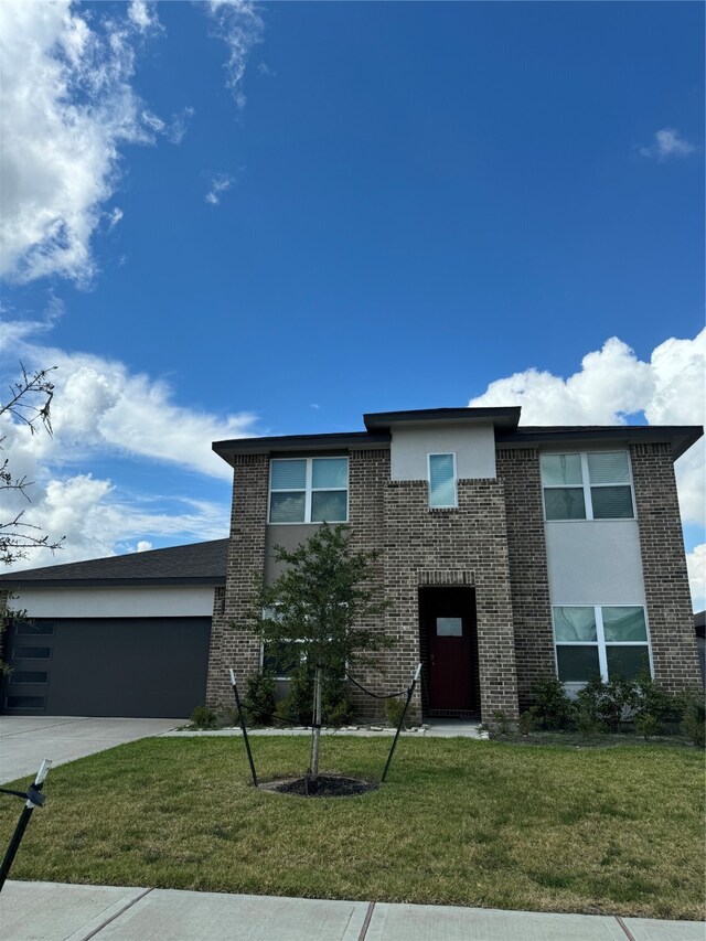 view of front of home with a garage and a front yard