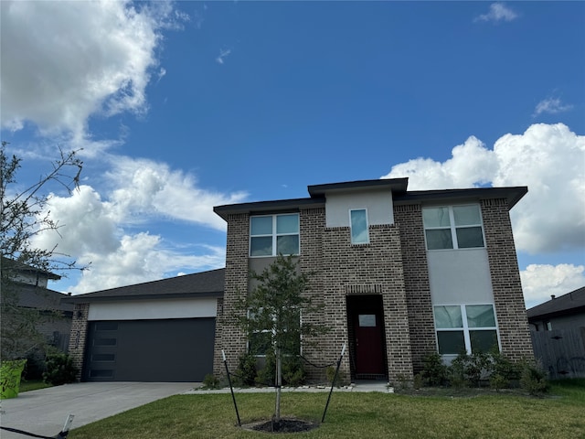 view of front facade with a front yard and a garage