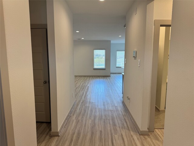 hall with light hardwood / wood-style flooring