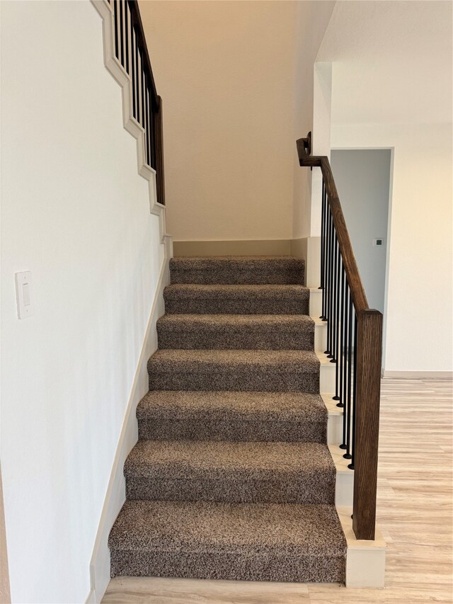 stairs featuring wood-type flooring