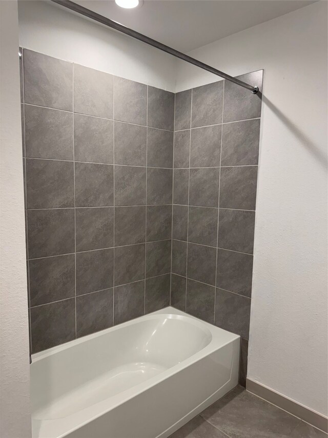 bathroom with tiled shower / bath combo and tile patterned floors