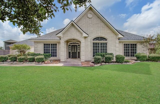 french provincial home with a front yard