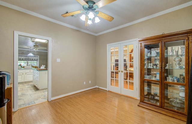 unfurnished room with light wood-type flooring, ceiling fan, french doors, and crown molding