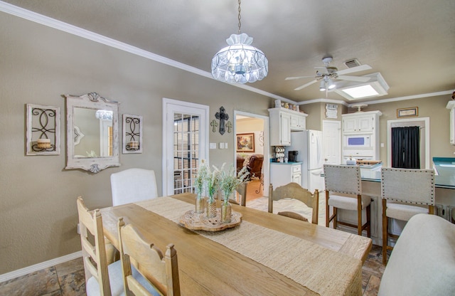 dining room with ceiling fan and crown molding