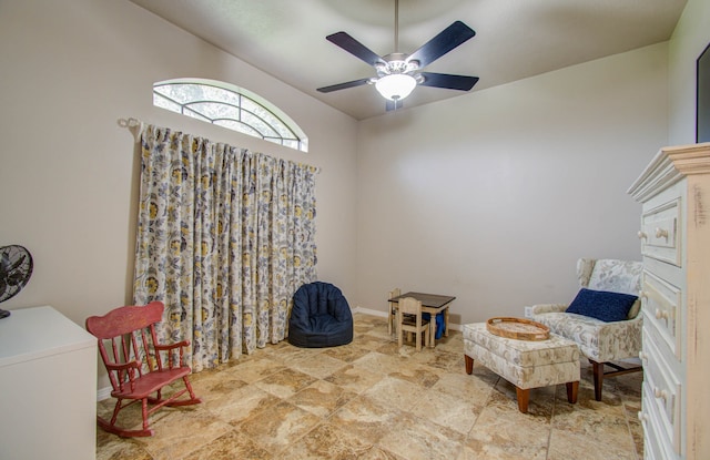 sitting room featuring ceiling fan