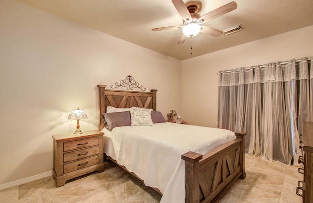 bedroom featuring a textured ceiling and ceiling fan