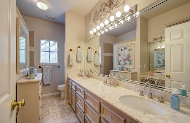 bathroom featuring vanity and toilet