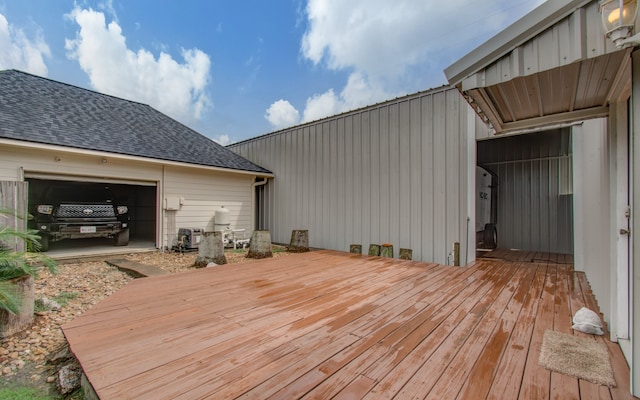 wooden deck featuring a garage