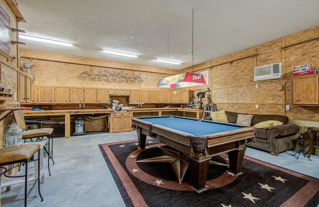 playroom with pool table and a wall unit AC