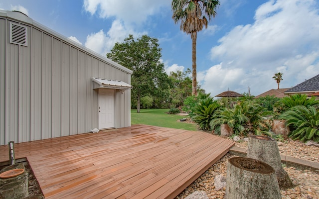 wooden terrace featuring a yard