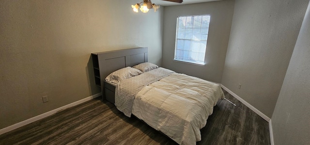 bedroom with ceiling fan and dark hardwood / wood-style flooring