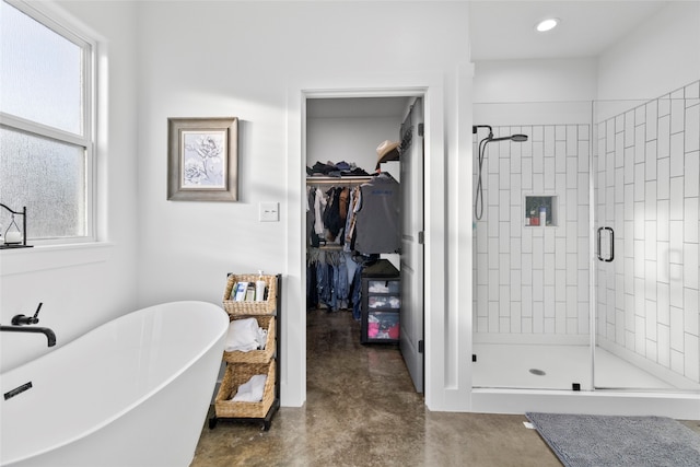 bathroom with separate shower and tub and concrete flooring