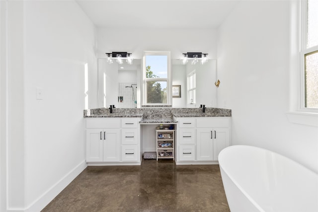 bathroom featuring vanity, concrete flooring, and a bath