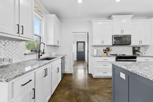 kitchen with white cabinetry, sink, a healthy amount of sunlight, and appliances with stainless steel finishes