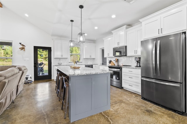 kitchen featuring a center island, a healthy amount of sunlight, white cabinetry, and appliances with stainless steel finishes