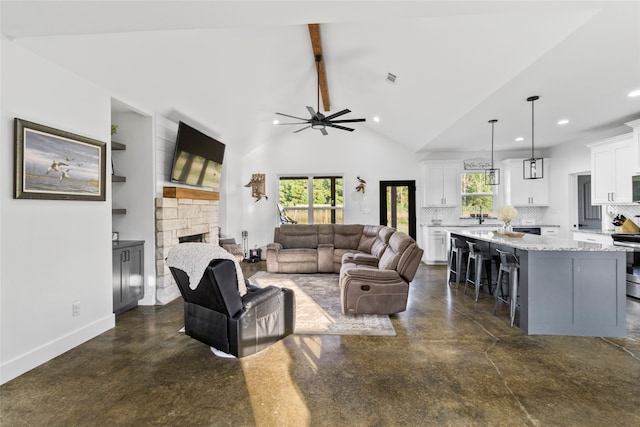 living room with ceiling fan, a fireplace, and lofted ceiling with beams