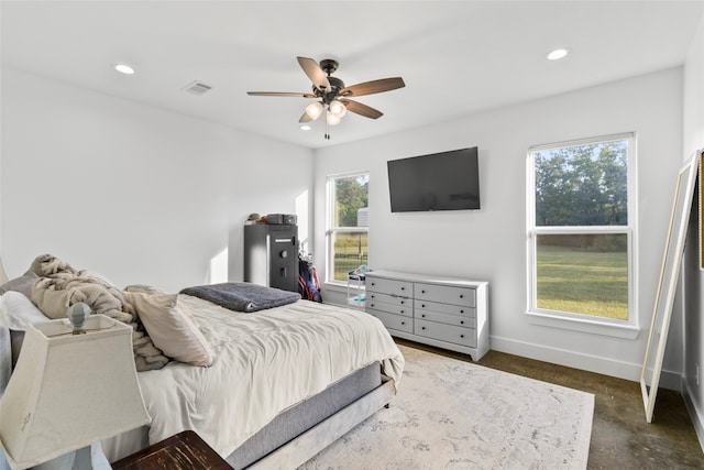 bedroom with ceiling fan and multiple windows