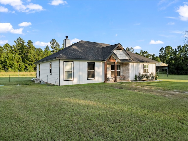 view of front of house with a front lawn and a carport