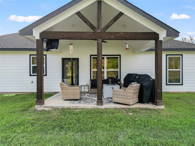 back of property with outdoor lounge area, a yard, and a patio area