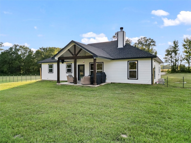 rear view of property featuring a lawn and outdoor lounge area