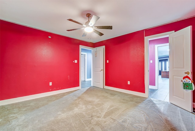 carpeted spare room with ceiling fan