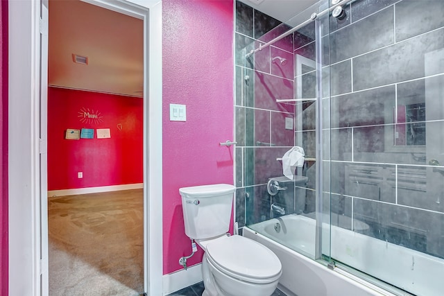 bathroom featuring shower / bath combination with glass door and toilet