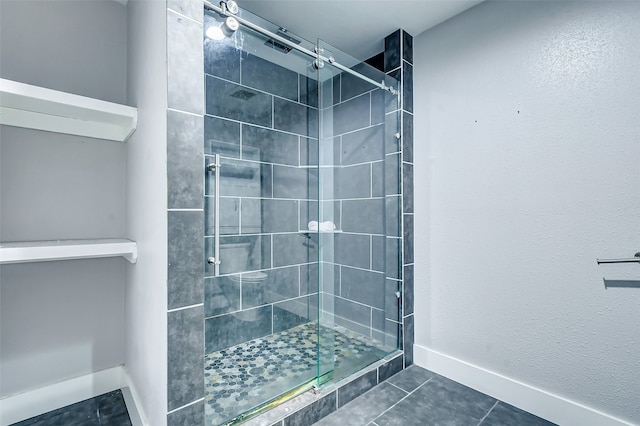 bathroom featuring a shower with door and tile patterned floors