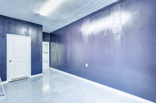 spare room with a textured ceiling