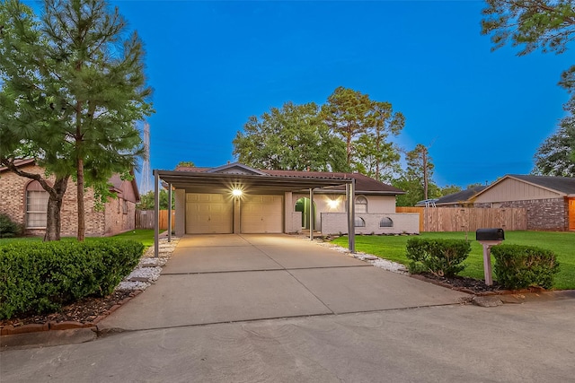 view of front of home with a lawn, a carport, and a garage