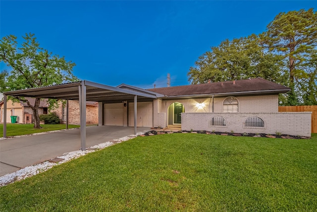 ranch-style house with a carport, a garage, and a front lawn