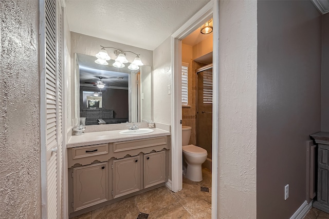 bathroom with vanity, ceiling fan, toilet, a textured ceiling, and an enclosed shower