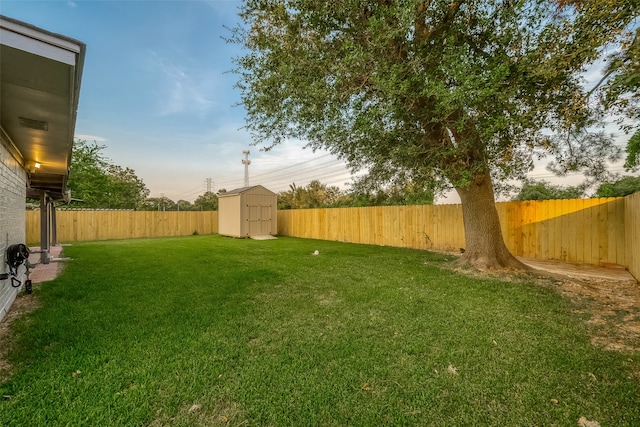 yard at dusk featuring a shed