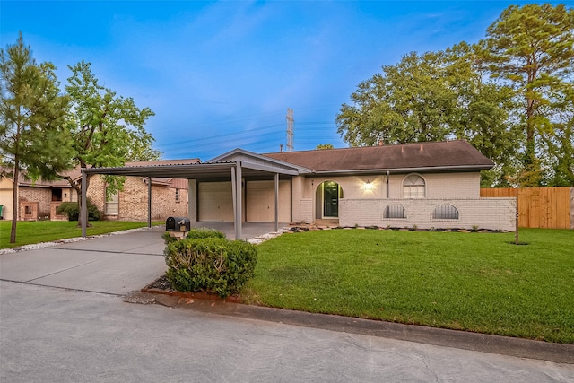 view of front of home with a front yard and a carport