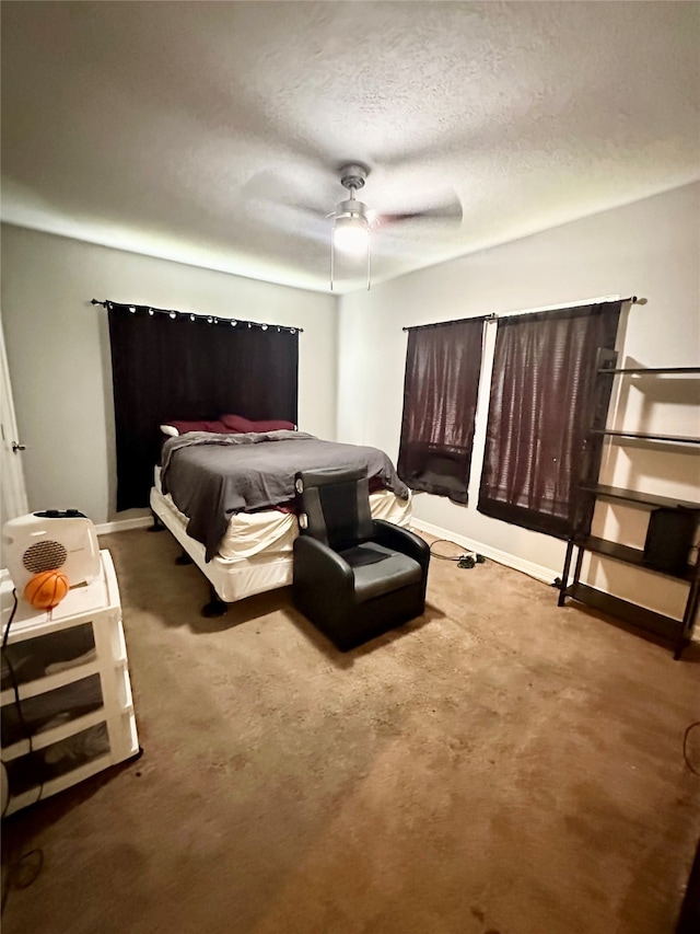 carpeted bedroom with a textured ceiling and ceiling fan