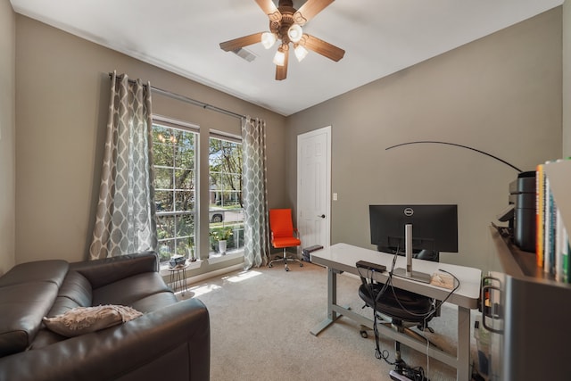 home office featuring a wealth of natural light, carpet floors, and ceiling fan