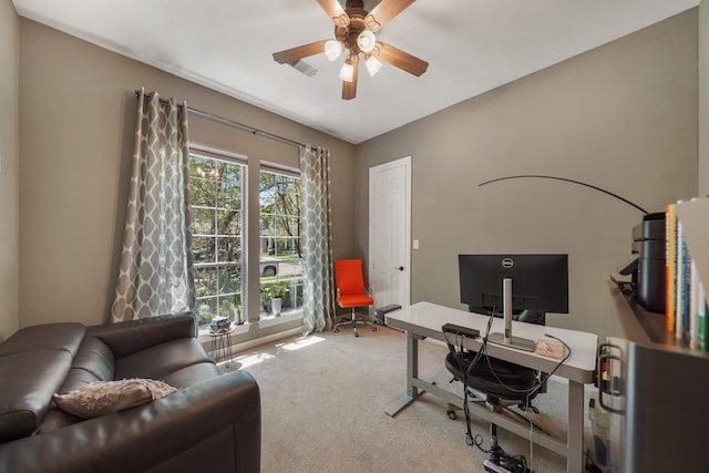 carpeted office space with visible vents and ceiling fan