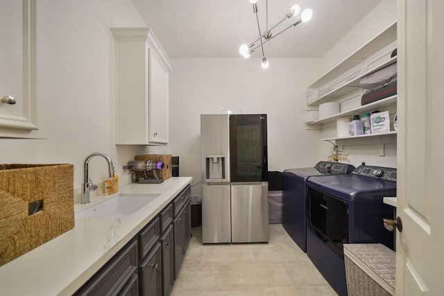 washroom with a sink and separate washer and dryer