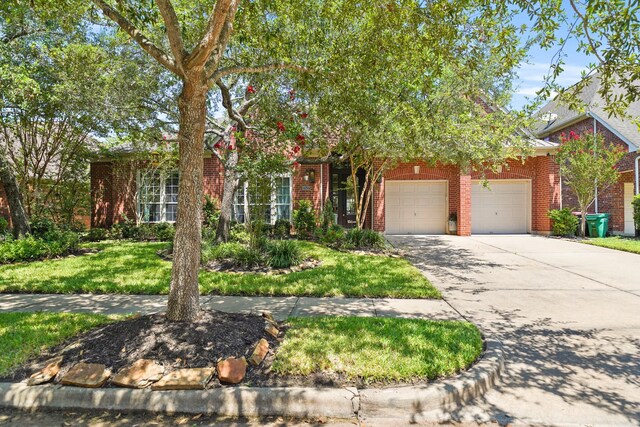 obstructed view of property with a garage and a front yard