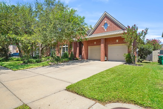 view of front of house featuring a garage and a front lawn