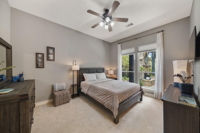 bedroom with baseboards, visible vents, ceiling fan, and light colored carpet