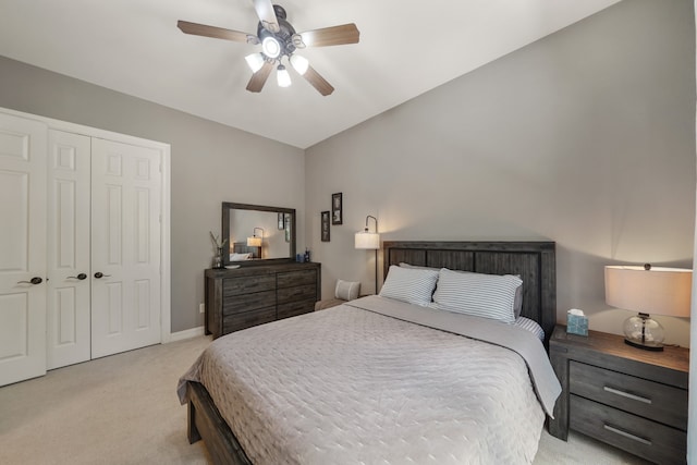 carpeted bedroom with ceiling fan and a closet