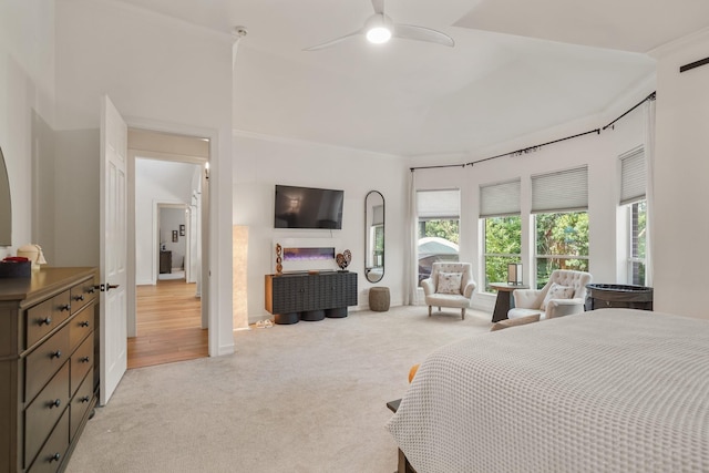 bedroom with light carpet, ornamental molding, and a ceiling fan