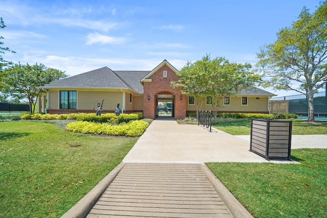 view of front of house featuring a front yard and brick siding